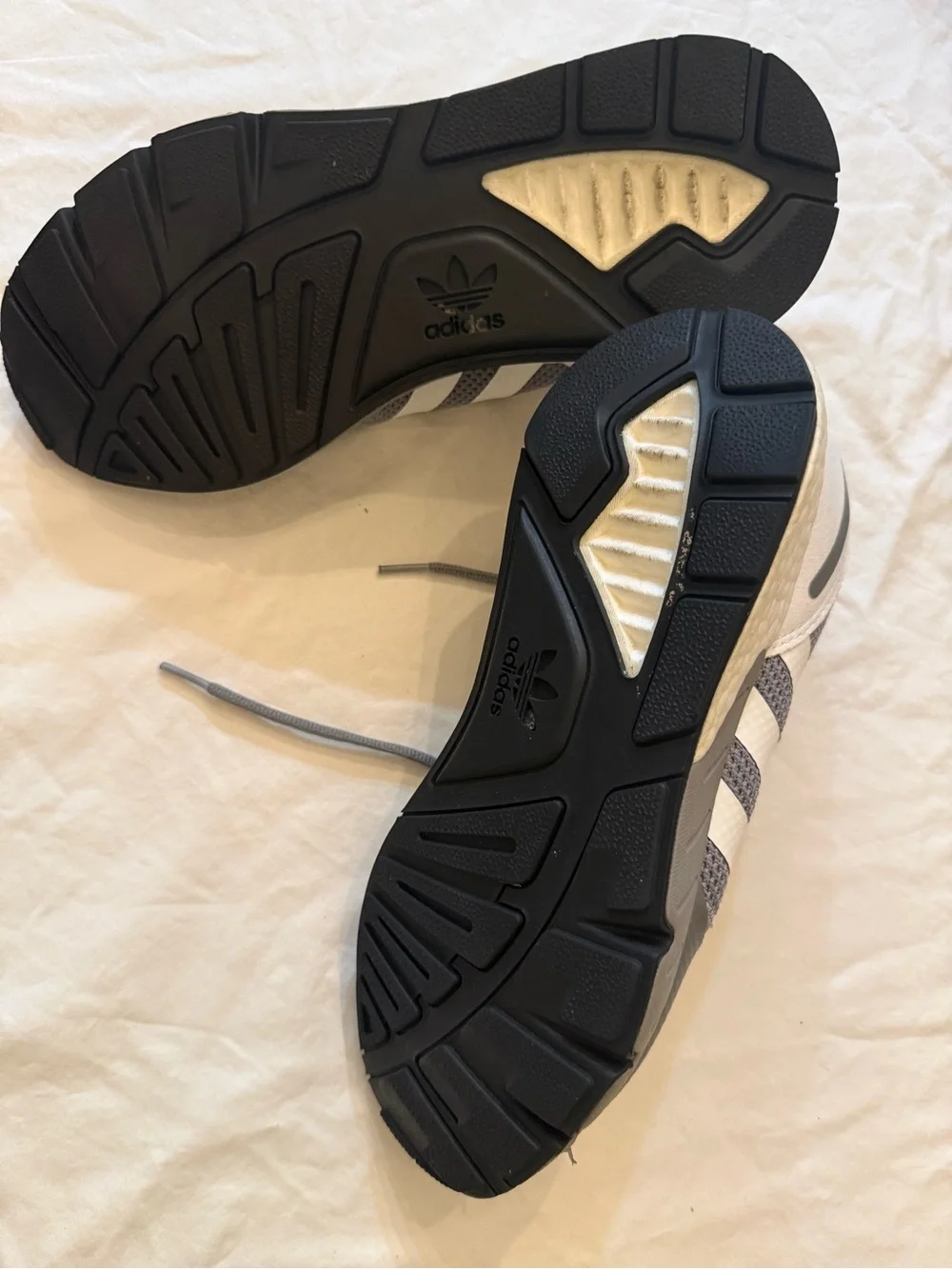 adidas gray and cream athletic shoe.